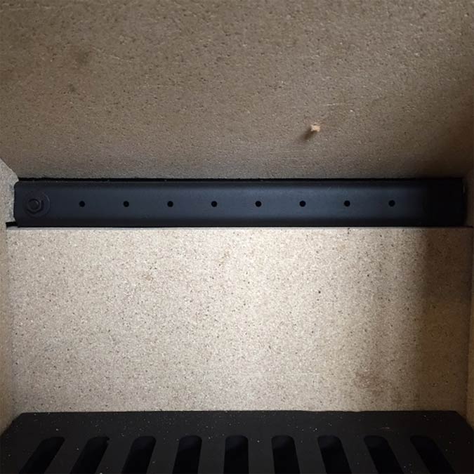 You can recognise a wood burning stove with a secondary burn system from the series of holes at the rear Holes at the rear of a stove with secondary burn